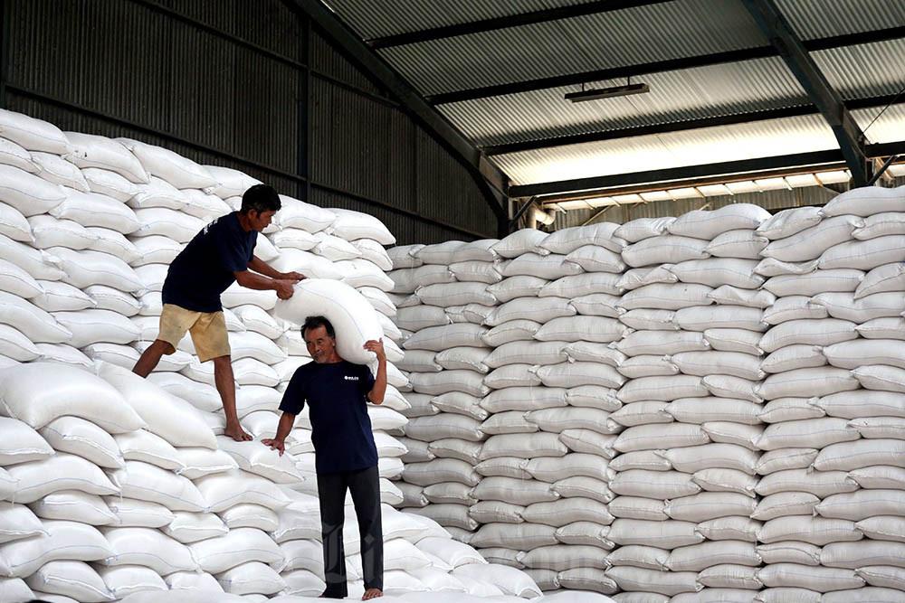 Buruh menata karung berisi beras di Gudang Bulog Divre Jawa Barat di Gedebage, Bandung, Jawa Barat. Bisnis/Rachman
